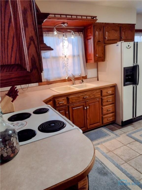 kitchen with plenty of natural light, sink, and white fridge with ice dispenser