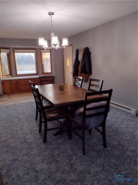 dining area featuring a chandelier and a baseboard radiator