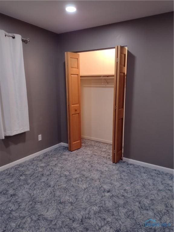 unfurnished bedroom with a closet and carpet