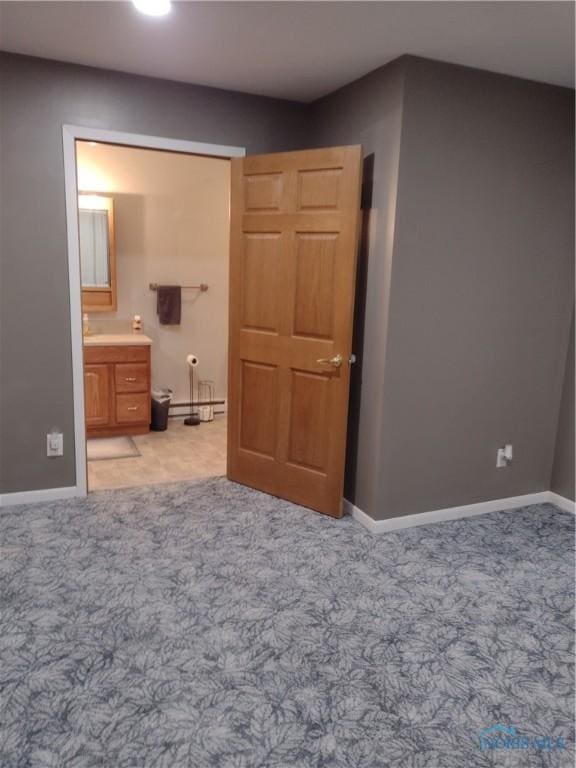 carpeted bedroom with ensuite bath