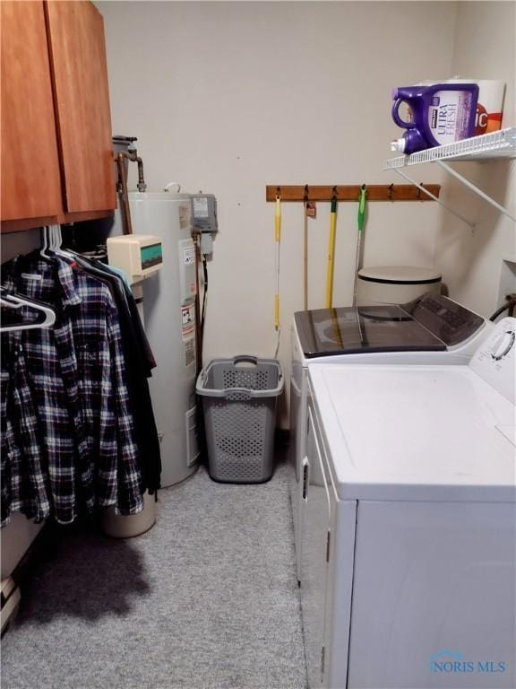 laundry room featuring cabinets, separate washer and dryer, and water heater