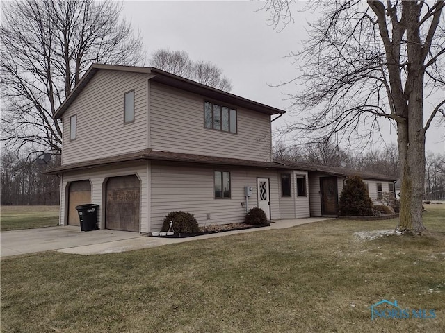 view of front of home with a front yard and a garage