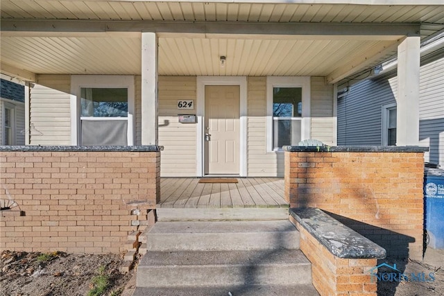 entrance to property featuring a porch