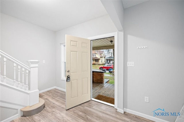 foyer entrance with light hardwood / wood-style floors