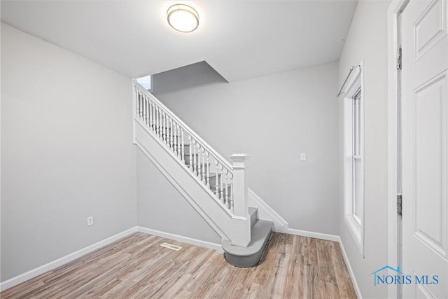 staircase featuring hardwood / wood-style flooring