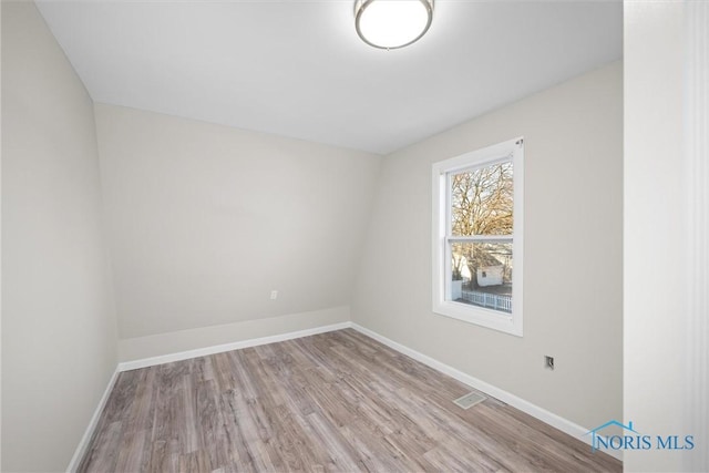 unfurnished room featuring light hardwood / wood-style floors