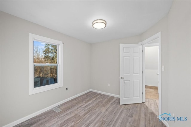 spare room featuring light wood-type flooring