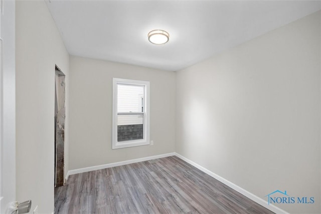 empty room with light hardwood / wood-style flooring