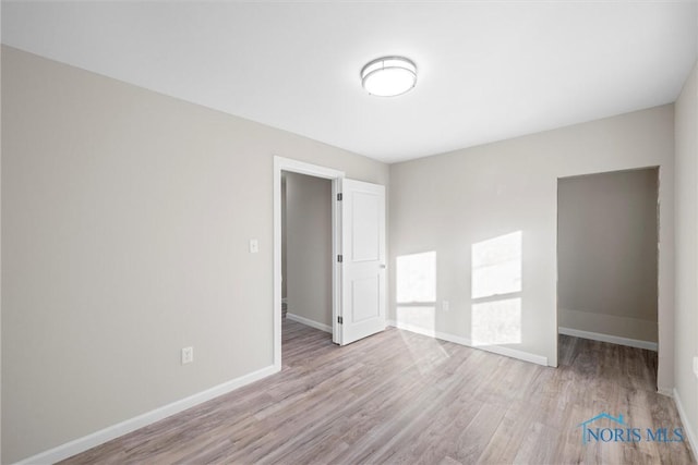 spare room featuring light wood-type flooring