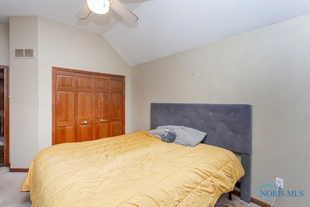 bedroom featuring light colored carpet, ceiling fan, vaulted ceiling, and a closet