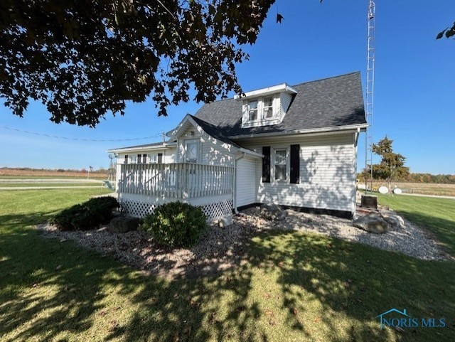 view of front of house featuring a front yard and a wooden deck