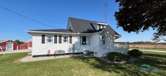 rear view of house with a lawn and a deck