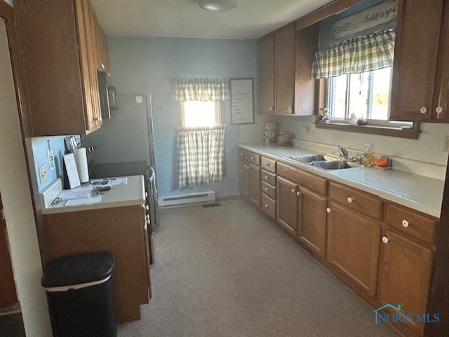 kitchen with sink and a baseboard heating unit