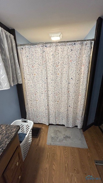 bathroom with vanity and hardwood / wood-style flooring