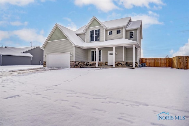 view of front of home with central AC unit and a garage