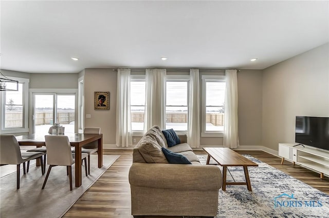 living room featuring dark hardwood / wood-style flooring and a notable chandelier