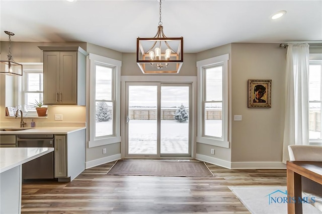 doorway with a notable chandelier, dark hardwood / wood-style floors, plenty of natural light, and sink