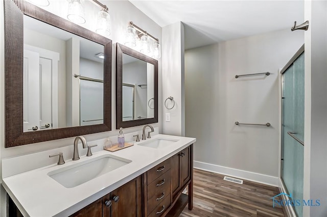 bathroom featuring a shower with door, vanity, and hardwood / wood-style floors