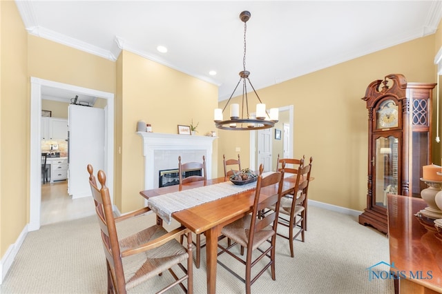 dining space featuring light colored carpet, crown molding, and a notable chandelier