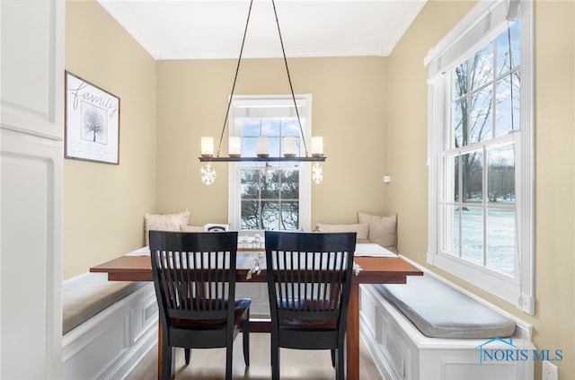 dining area with breakfast area, crown molding, and a healthy amount of sunlight