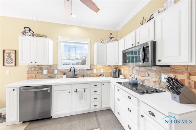 kitchen featuring appliances with stainless steel finishes, tasteful backsplash, and white cabinetry