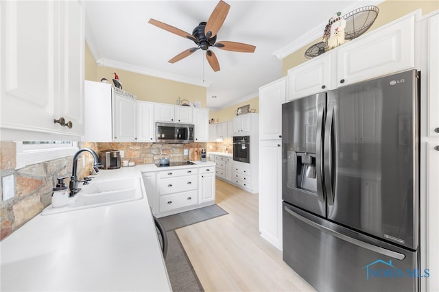 kitchen with sink, white cabinetry, ornamental molding, and appliances with stainless steel finishes