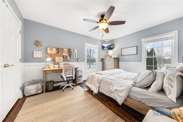 bedroom with ceiling fan, a closet, and dark wood-type flooring