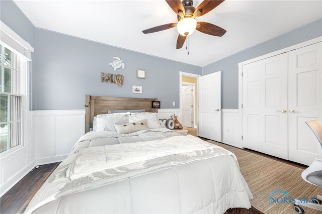 bedroom featuring ceiling fan, dark wood-type flooring, and a closet