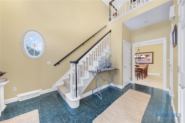 stairs featuring a towering ceiling