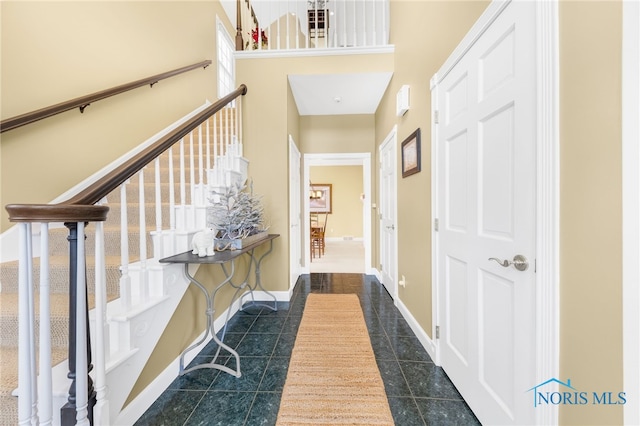 hallway featuring dark tile patterned flooring