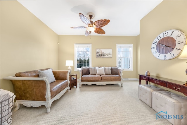 carpeted living room with ceiling fan