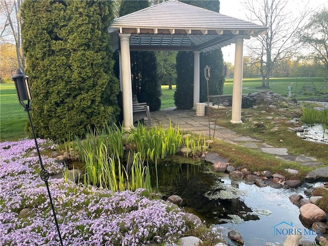 view of property's community featuring a gazebo and a lawn