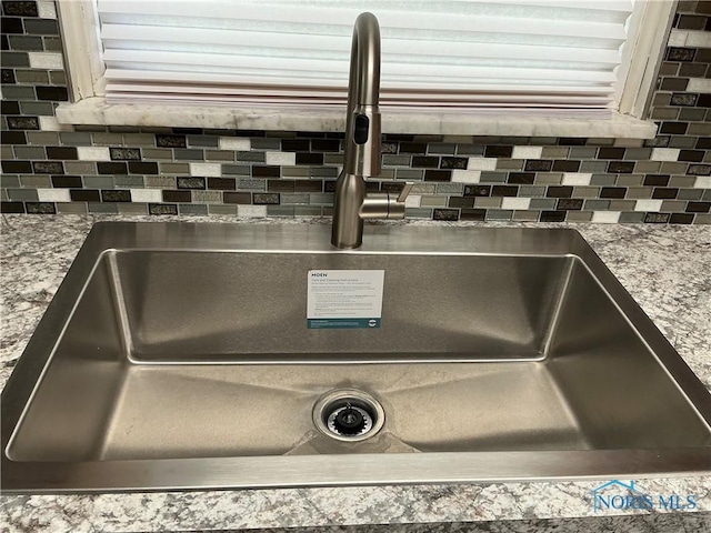 room details with sink and tasteful backsplash