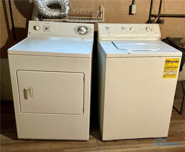 washroom featuring hardwood / wood-style floors and separate washer and dryer