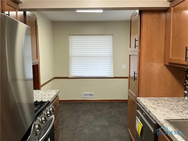 kitchen with light stone counters and stainless steel appliances