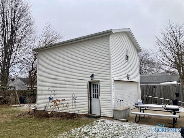 rear view of property featuring a garage