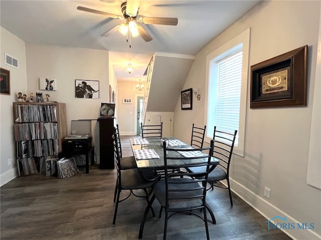 dining space featuring ceiling fan with notable chandelier and dark hardwood / wood-style floors