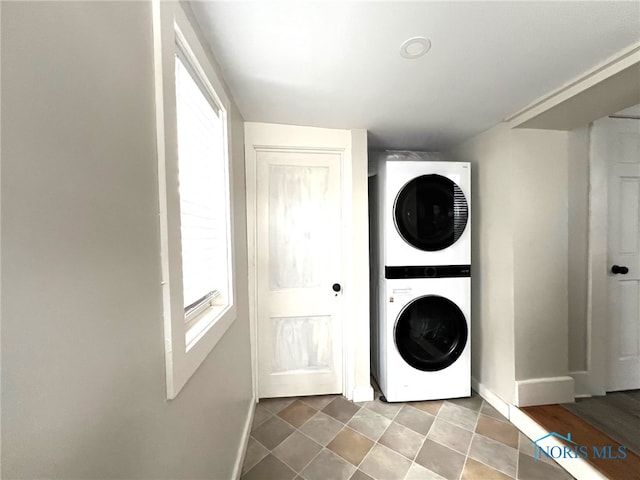 laundry room with stacked washer / drying machine