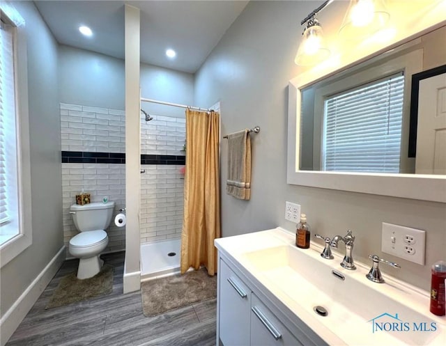 bathroom featuring toilet, hardwood / wood-style floors, vanity, and a shower with shower curtain