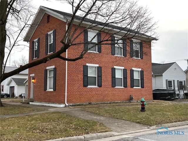 view of property exterior featuring a lawn