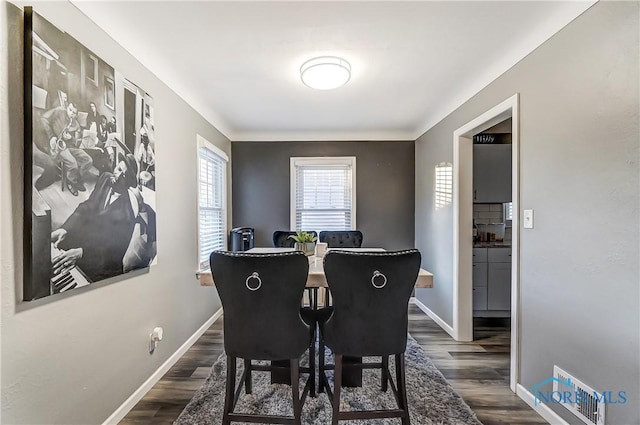 dining area with dark hardwood / wood-style flooring