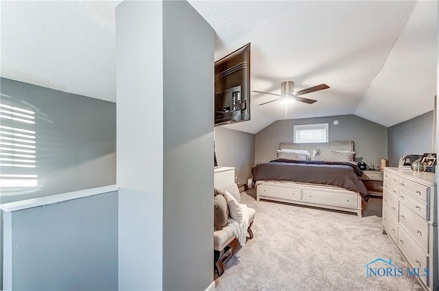 carpeted bedroom featuring vaulted ceiling and ceiling fan