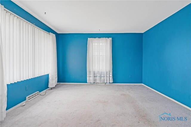 unfurnished room featuring carpet