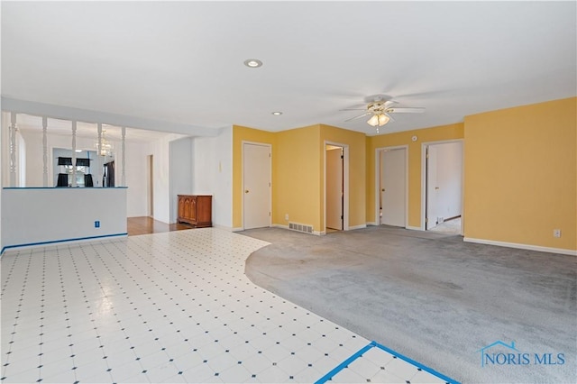 unfurnished living room with ceiling fan and light carpet