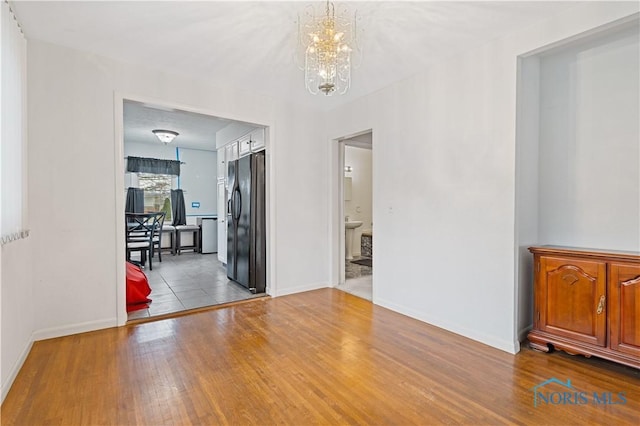 interior space with a chandelier and light wood-type flooring