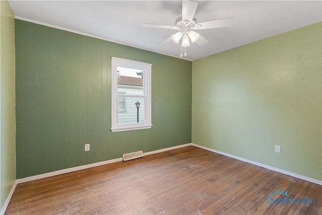 empty room featuring hardwood / wood-style floors and ceiling fan