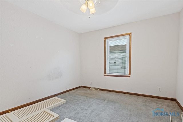 carpeted spare room with ceiling fan