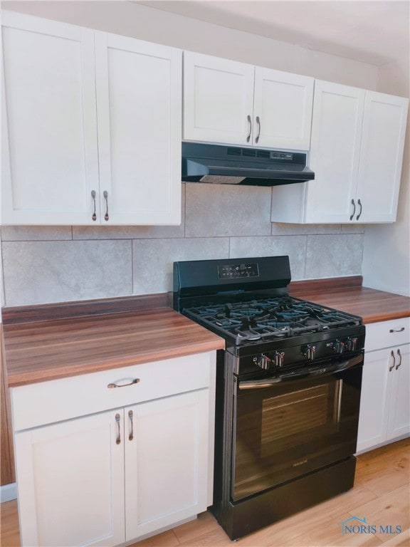 kitchen featuring black gas range, wooden counters, and white cabinetry