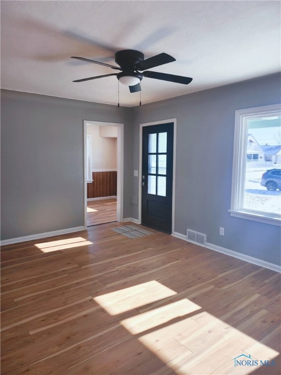 entryway with ceiling fan and wood-type flooring