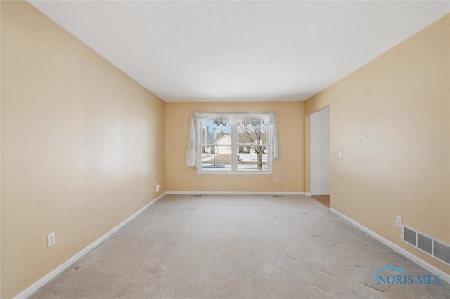 empty room featuring light colored carpet